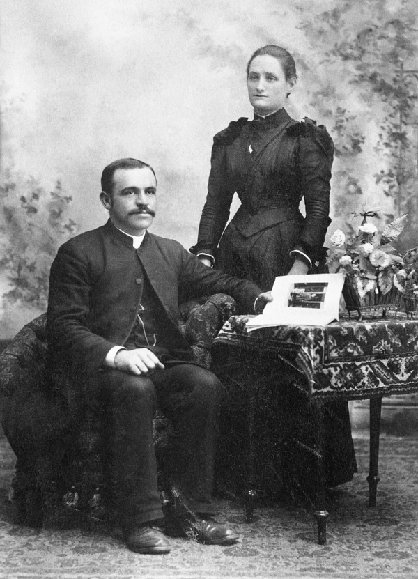 Original title:  Bishop George Holmes and Mrs. Holmes. Date: [ca. 1890]. Photographer/Illustrator: McDermid Studio, Edmonton, Alberta. Image courtesy of Glenbow Museum, Calgary, Alberta.