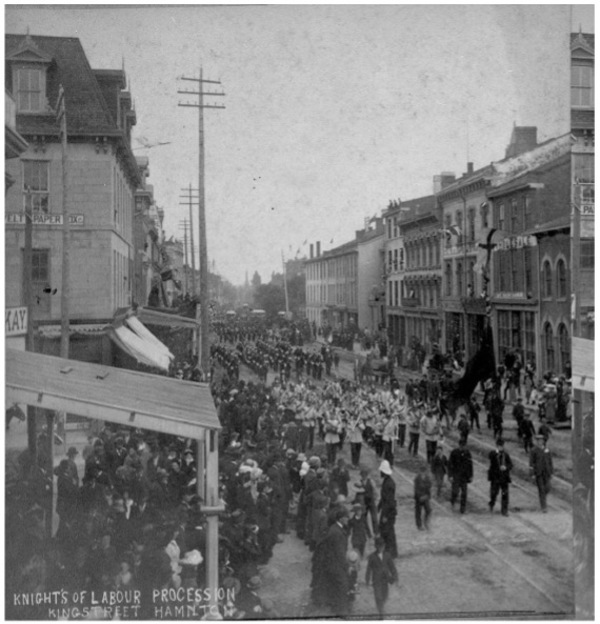 Original title:  Few photographs of the Knights of Labor remain, but this surviving photo illustrates the union in action, marching down King Street in Hamilton, where McVicar lived, in 1885. Image courtesy of the Edward McCann Collection, Library and Archives Canada. 
https://definingmomentscanada.ca/all-for-9/historical-articles/katie-mcvicar-knights-of-labor-organization-of-women-workers/